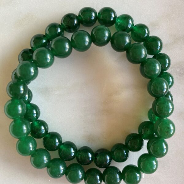 jade beaded bracelets on a marble surface
