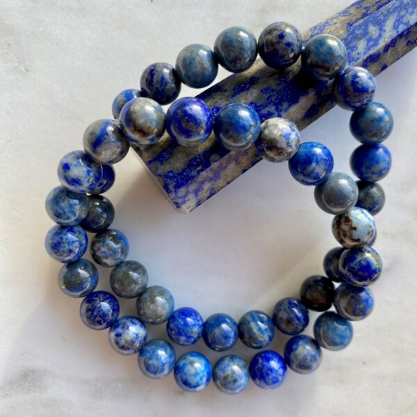 lapis lazuli beaded bracelets on a marble surface