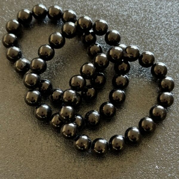 black beaded bracelet in black rough surface