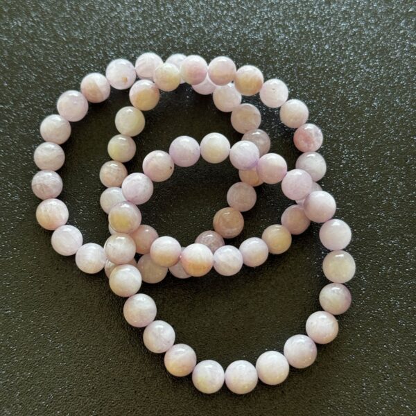 Soft pink kunzite crystal with a delicate, translucent glow, often associated with emotional calmness, warmth, and gentle heart-centered energy.